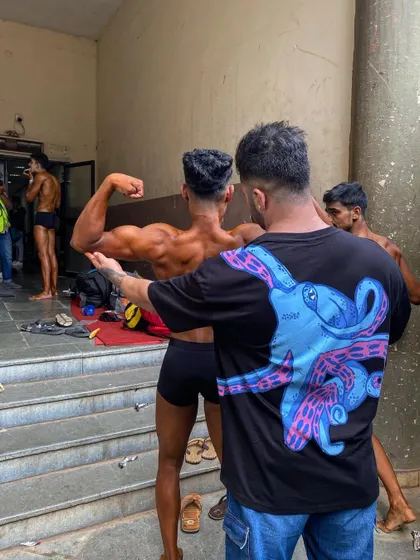 Another angle of me coaching a client on his back pose. This hands-on approach ensures nothing is left to chance.