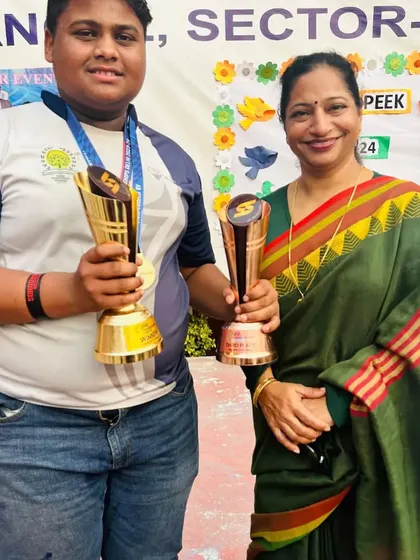 A champion player receiving her trophies from the school principal. We celebrate every success.