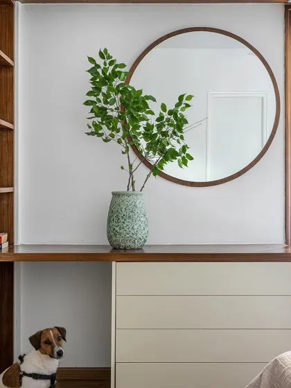 A detail shot of a dresser and mirror in our 'Pepper and Coffee' project, featuring our furry friend. This shows our attention to creating personal spaces that accommodate the whole family.