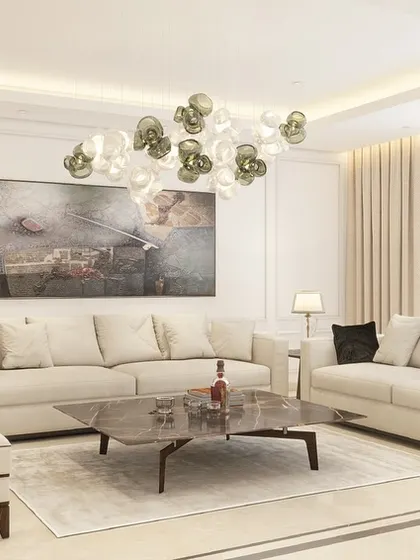 A 3D visualization of a living room with a neutral color palette, designed to feel open and spacious. The custom sofas and armchairs are arranged to create an elegant and welcoming atmosphere.