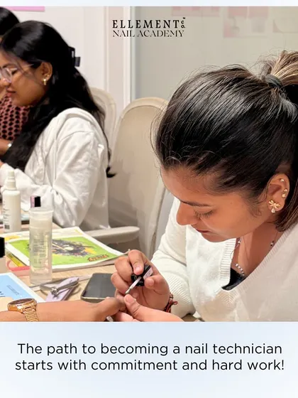 The path to becoming a nail technician starts with commitment and hard work. A close-up of a student focused on perfecting her technique.
