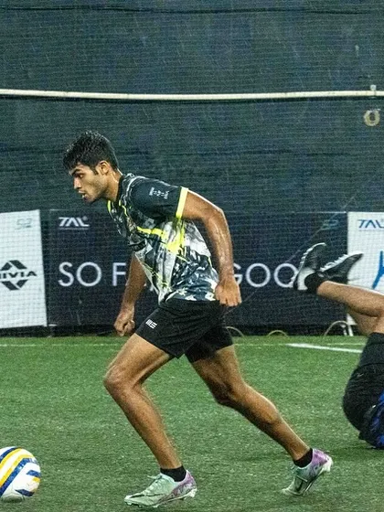 A player dribbles past a sliding tackle in a fast-paced 7-a-side game. My training focuses on agility and quick decision-making under pressure.