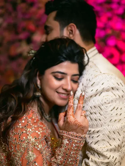 A tender moment of love and victory after the ring ceremony. The bride's hand, now with the ring, shows her joy.
