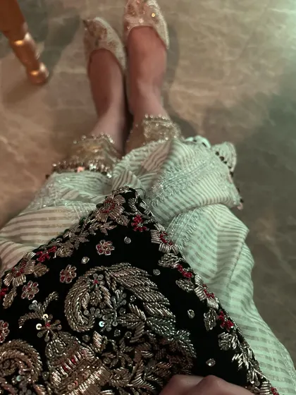 A detail shot showing my embroidered bag and juttis, which complete the traditional look.