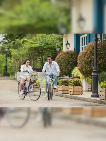 A cheerful bike ride down a picturesque, European-style street. This shot captures a sense of adventure and shared fun, perfect for a dynamic pre-wedding album.