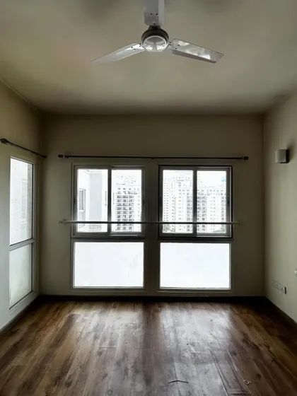 The guest room before we added the custom window seat, showing a plain wall and window.