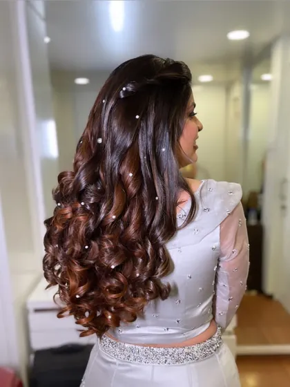 Glamorous curls for a sangeet night. I scattered pearls throughout the hair to add a touch of sparkle and magic to these beautiful, bouncy curls.