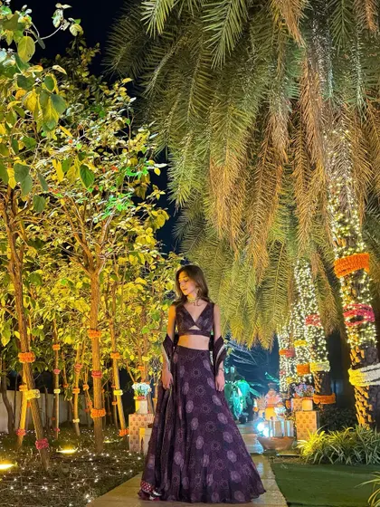 Another look at this gorgeous lehenga, this time set against a backdrop of beautifully lit palm trees.