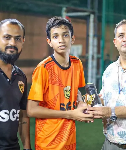 Viaan Tharval with his coaches and his Player of the Month award. We foster a supportive environment where players and coaches celebrate success together.