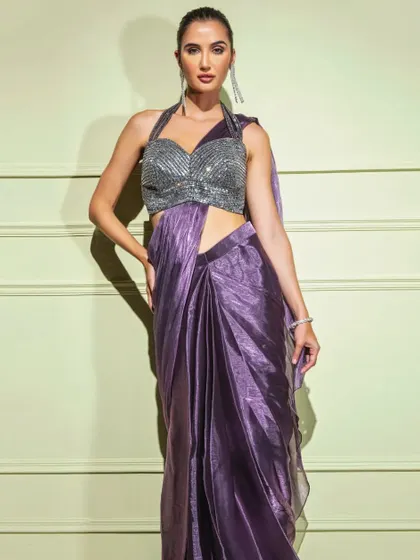 A full-length shot of the metallic purple drape saree, emphasizing its vibrant color and glamorous appeal.