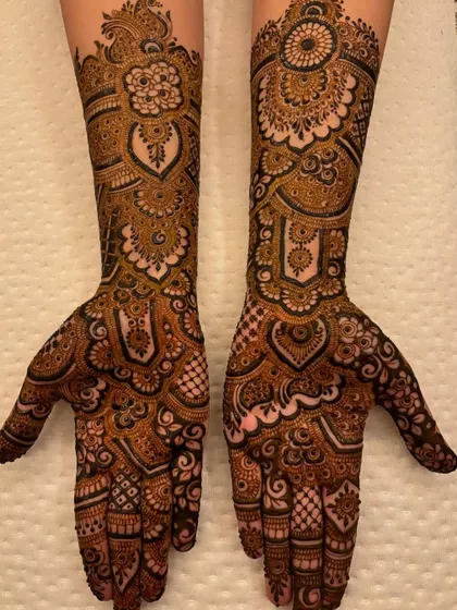 The full symmetrical design, held up to show the beautiful heart shapes created when the palms are brought together.