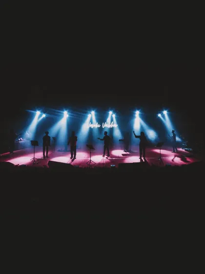 The band silhouetted against the stage lights. A cool, atmospheric shot from our performance at Srirangapatna Dasara.