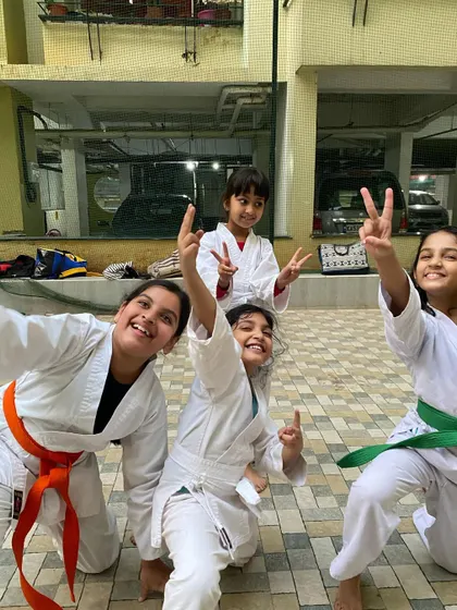 All smiles and peace signs after a great training session. We foster a positive and encouraging atmosphere where every student feels like part of the team.