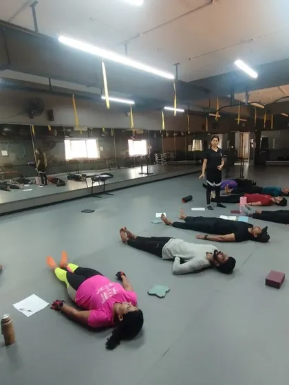A moment of rest and recovery during an intense practical session. We teach our future trainers the importance of cooldowns and relaxation techniques for client success.