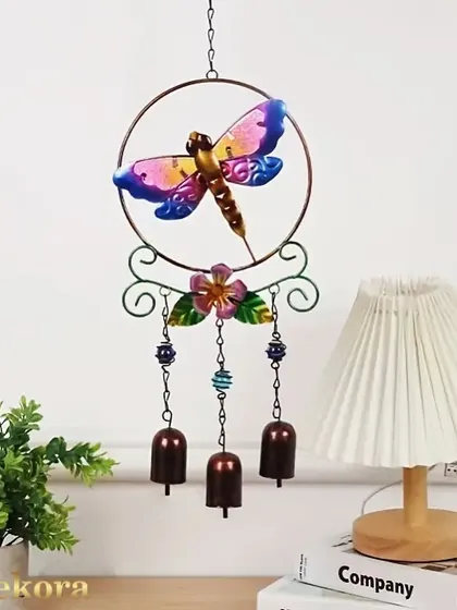 A colorful metal wind chime featuring a dragonfly and bells. This piece adds a touch of whimsy and a gentle sound to your balcony, garden, or any room with a breeze.