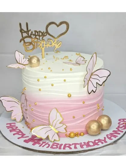 An elegant pink ombre butterfly cake for a 14th birthday. This basic vanilla cake is decorated with pink and gold butterflies, golden spheres, and a beautiful "Happy Birthday" topper.