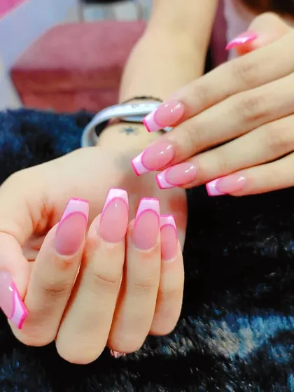 A still shot showing the detail of this double-pink French manicure. The clean lines and glossy finish highlight the quality and precision of the application on these elegant square extensions.
