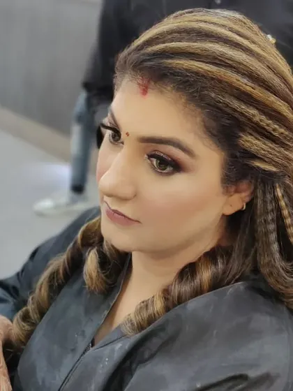 A modern and trendy hairstyle featuring a mix of crimped textures and soft curls. This look adds volume and dimension, perfect for a cocktail party or reception.