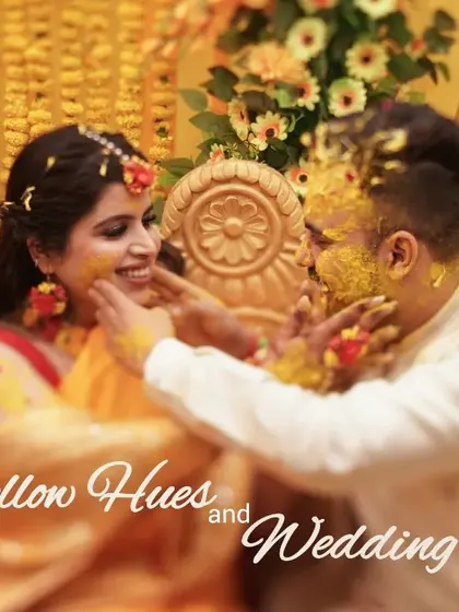 "Yellow Hues and Wedding Bliss." A playful moment where the bride and groom apply Haldi to each other.