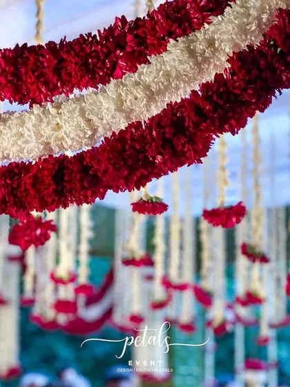 Another detail shot of the floral garlands, capturing the freshness and vibrancy of the flowers. These decorations add a touch of natural beauty and elegance to any wedding.
