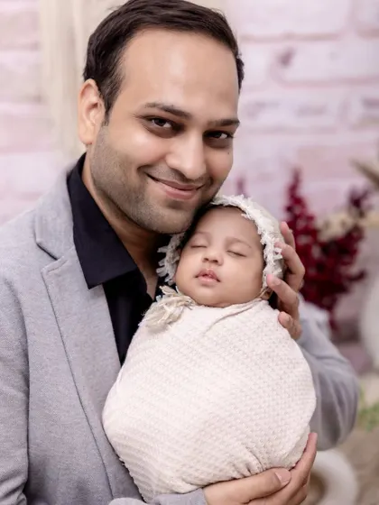 A father’s gentle embrace. We make sure to capture individual portraits of each parent with the baby, highlighting that unique and special connection.