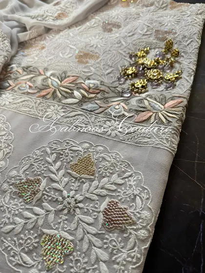 A flat-lay of the suit, showing the coordinated design of the kurta and dupatta.
