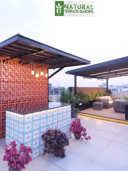 A wide view of the two main structures on the Gurgaon rooftop: the bar and the pergola lounge, creating a perfect entertainment zone.