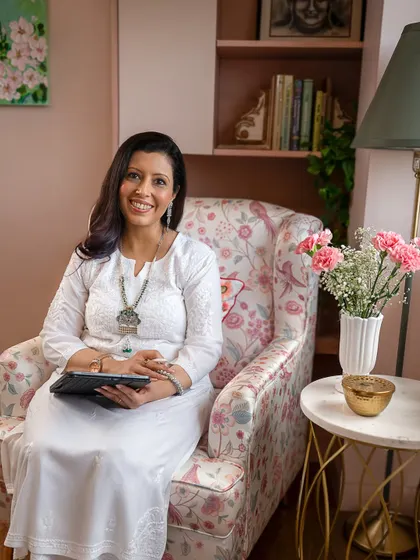 A branding photo should tell a story about what you do. Here, seated in her own cozy office chair, she looks ready to connect, creating a sense of trust and comfort for potential clients.