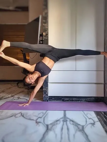 Using the wall for support in this standing split variation (Visvamitrasana). Props can be excellent tools for safely exploring the alignment of advanced postures before trying them unsupported.