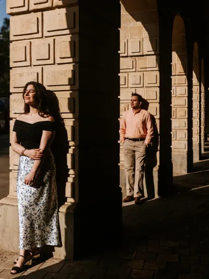 A more artistic composition using strong shadows and light. The separation of the couple in the frame adds a touch of drama and highlights them as individuals within the partnership.