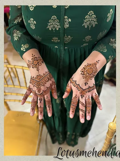 A lovely guest mehendi design combining a central floral motif with delicate patterns on the fingers, perfect for a festive celebration.
