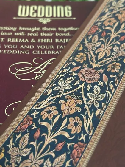 A detail shot of the intricate floral border that runs along the inserts of the deep blue and maroon suite.