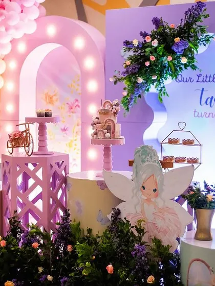 The full stage setup for "Our Little Butterfly" Tarini's first birthday. The design features a soft pastel color palette, light-up arches, and plenty of whimsical fairy and butterfly elements.