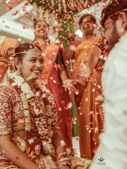 A shower of petals rains down on the couple, a candid moment of celebration and joy during their wedding ceremony.