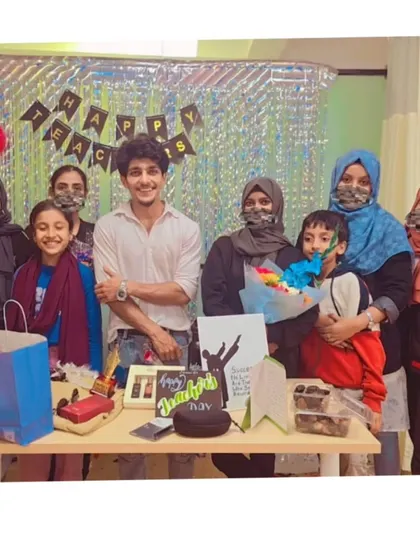 A group photo with students and parents on Teacher's Day, highlighting the family-like bond we share.