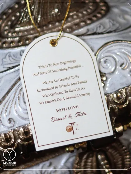 Every detail matters. This personalized gift tag, part of a bespoke Sufi-themed wedding hamper, carries a heartfelt message from the couple, adding a layer of personal connection to their gift of gratitude.