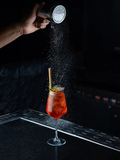 Blending unique ingredients with creativity and passion. Here, a final dusting of powder adds another layer of aroma and texture to one of our spritz-style cocktails.