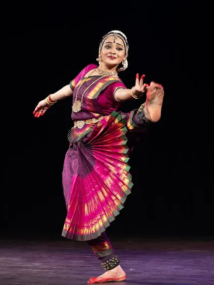 A challenging pose that requires both strength and flexibility, demonstrating the physical rigor of Bharatanatyam.