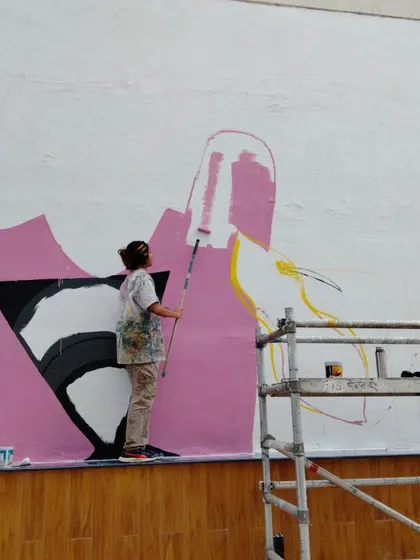Me on a roller, laying down the base colors for the massive sports arena mural in Hyderabad.