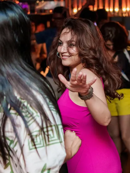 A guest dancing and interacting with friends, soaking in the fun and social vibe of the rooftop party.
