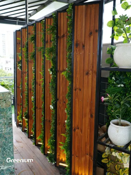 A creative partition solution for a terrace. These rotating wooden panels provide privacy while adding a stylish, dynamic element to the outdoor space, complemented by subtle floor lighting.