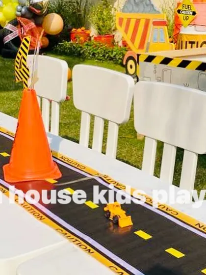 Detailing on the construction-themed table. A road-like table runner with toy trucks and traffic cones makes the kids' dining experience interactive and fun.