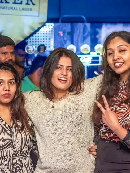 A group of friends having a great time, with one flashing a peace sign. The energy is always positive and fun.