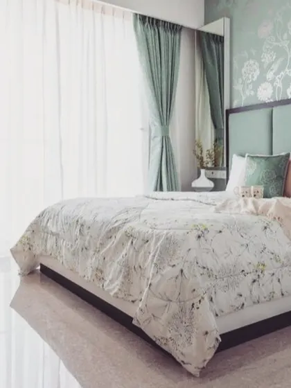 In this serene bedroom, we applied a delicate floral pattern in a soft mint green. This technique adds a layer of sophistication and texture, creating a tranquil and elegant atmosphere perfect for a restful space.