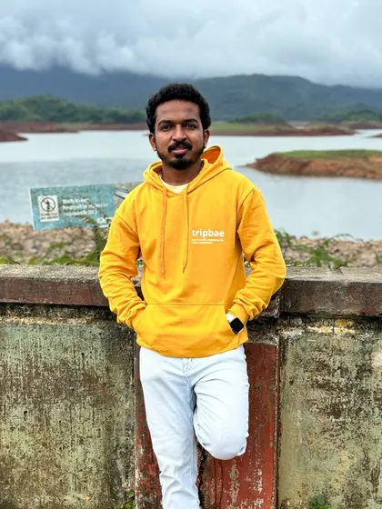 Our trip captain posing by the Banasura Sagar Dam in Wayanad, wearing our signature Tripbae hoodie.