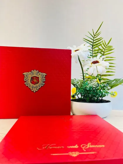 Another view of our bold red boxed invitation with a custom metal crest, perfect for making a strong first impression.