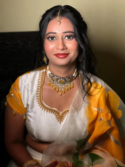 A smiling portrait of the bride-to-be at her Haldi ceremony. The makeup is bright and cheerful, just like the occasion itself.