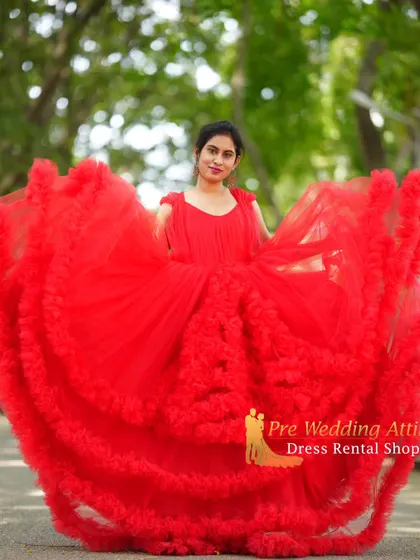 The red ruffled gown spread out to its full, impressive width.