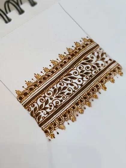 A detailed shot of a vine-style border pattern. The contrast between the bold lines and delicate leaves is something we work on to create visually appealing designs.