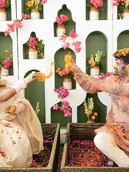 A joyous moment of the couple during their haldi, with a backdrop inspired by the rich culture of Kerala and Rajasthan.
